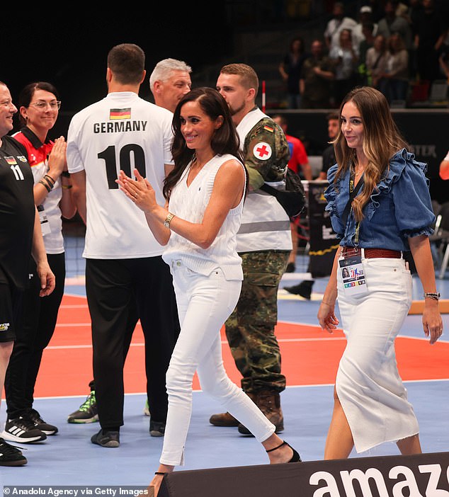 Meghan claps her hands as she walks along the volleyball court on Thursday