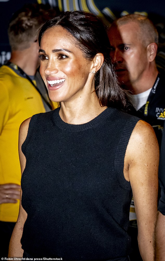 Meghan smiles to the crowds during an event at the games last night