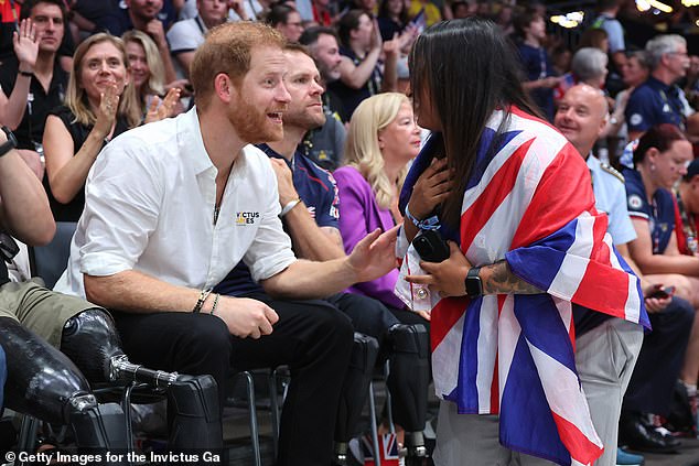 Prince Harry speaks enthusiastically to a Team GB supporter on Monday