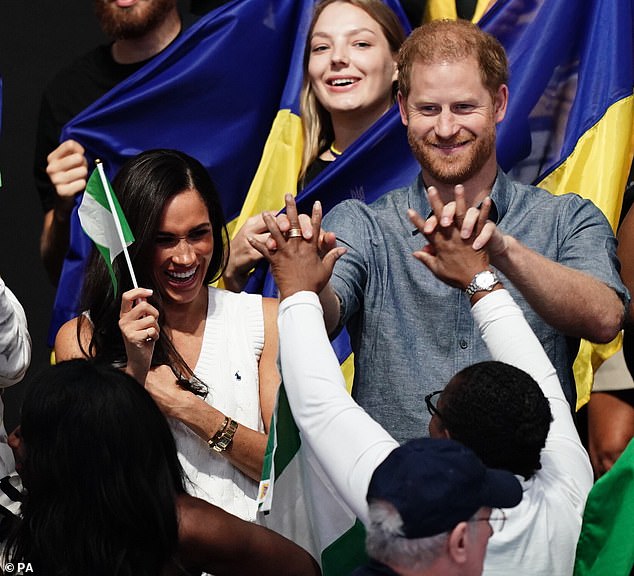 The Duke and Duchess enthusiastically join in with the crowd as they watch the sitting volleyball