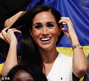 Today, as she watched the wheelchair volleyball, she couldn't help but play with her locks as she tucked them away from her face and behind her ear