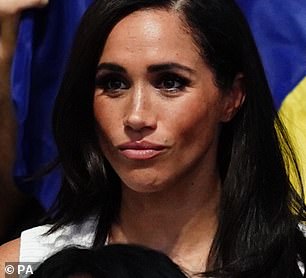 Today, as she watched the wheelchair volleyball, she couldn't help but play with her locks as she tucked them away from her face and behind her ear