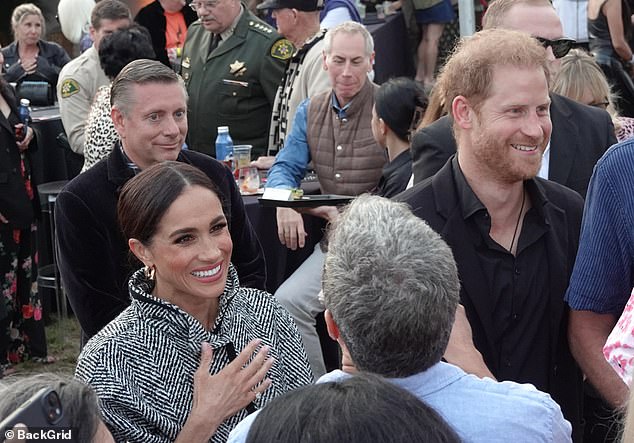 She kept her hair in a sleek up-do, adding a touch of glamour to the ensemble with a pair of gold hoop earrings and a simple gold watch