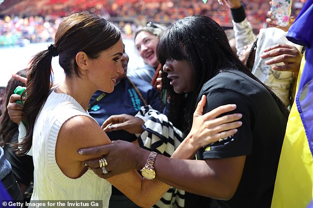 In the above image, Meghan appears to be having a heartfelt conversation with a woman while they held each others arms