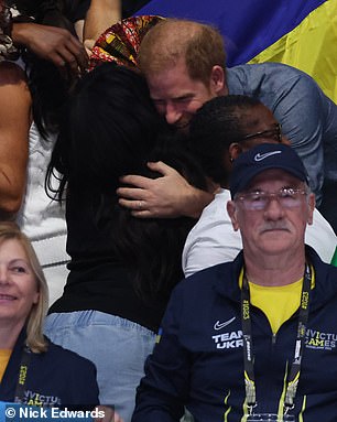 Harry and Meghan share hugs with people in the crowd during today's outing