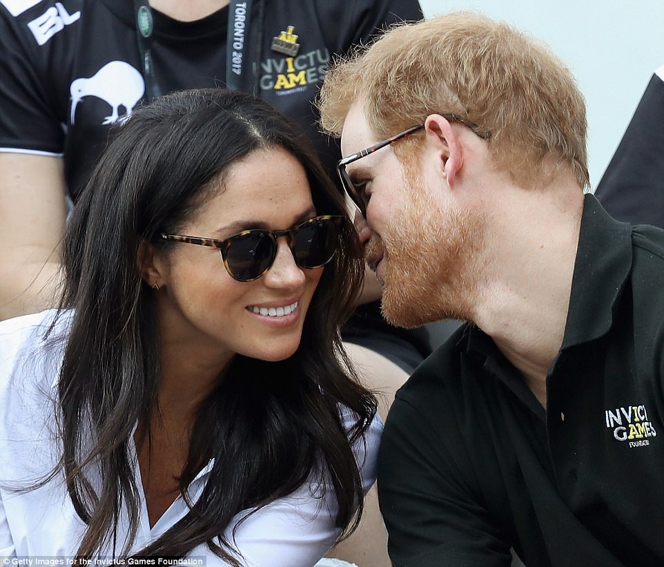 Sweet nothings: The pair looked at ease as they put on a loved up display, despite the attention of the world's media 