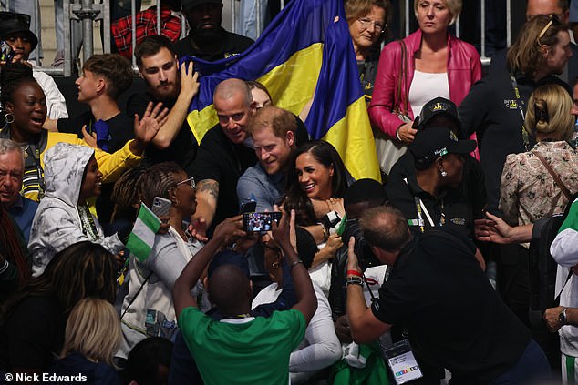 The Duke held his wife close as the pair sat at the Merkur Spiel Arena, in Dusseldorf, Germany today