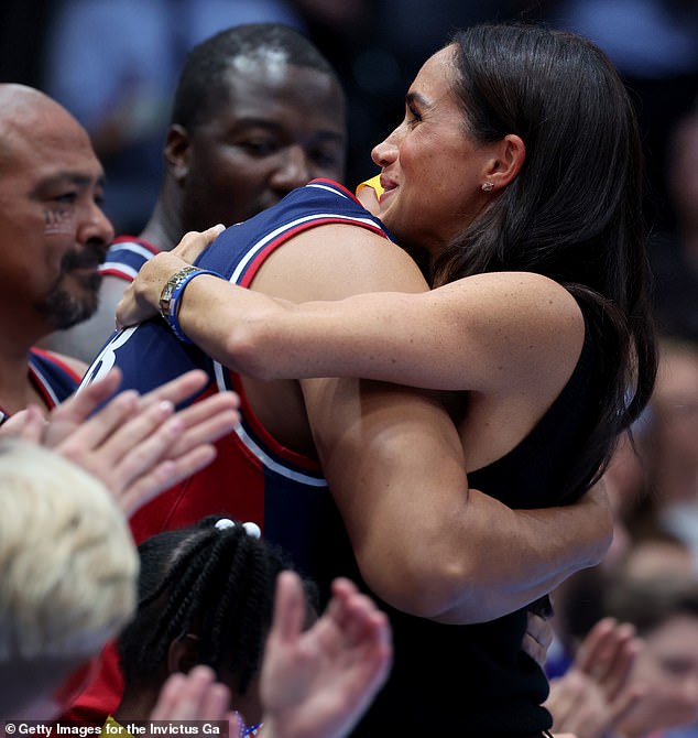 Harry and Meghan (pictured right) took part in the gold medal presentation ceremony in front of a packed crowd