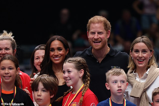 The Duke and Duchess pose for a photo with children at the Merkur Spiel-Arena today