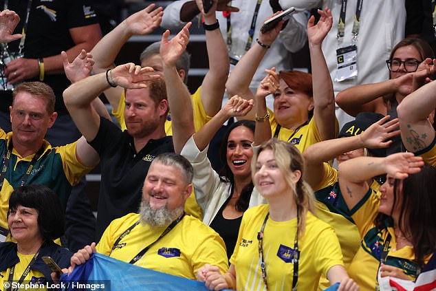 Prince Harry and Meghan Markle wave their hands at the wheelchair basketball match today