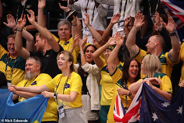 Prince Harry and Meghan Markle wave their hands at the wheelchair basketball match today