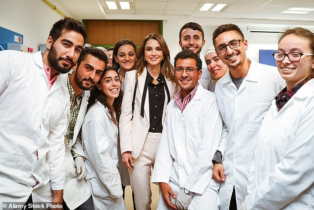 Queen Rania displaying her impeccable sense of style in an off-white trouser suit at the German Jordanian University in May 2016