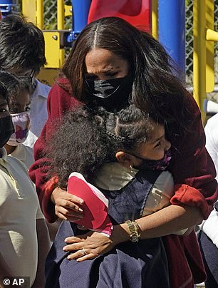 Meghan Markle hugs children at the school in Harlem during the September 2021 visit where she read her book