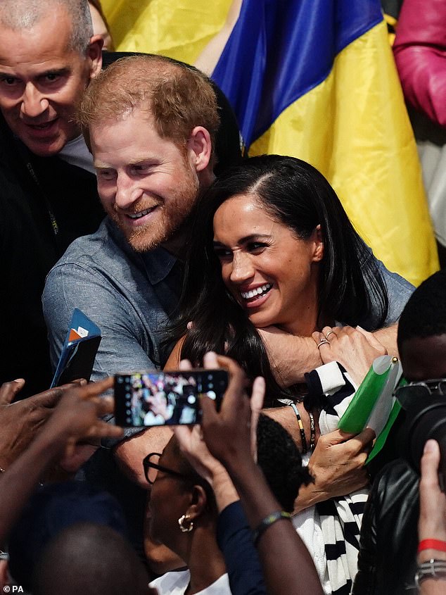 The Duke and Duchess of Sussex put on an extraordinary red carpet-style display of flirting and affection at the Invictus Games on Thursday