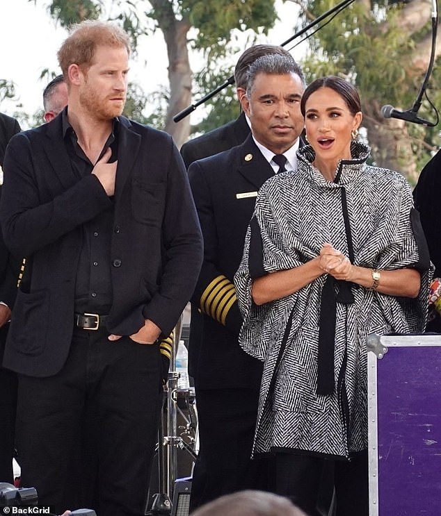 Meghan Markle was effortlessly chic in a monochrome, statement coat as she attended a star-studded charity fundraiser in Santa Barbara last night