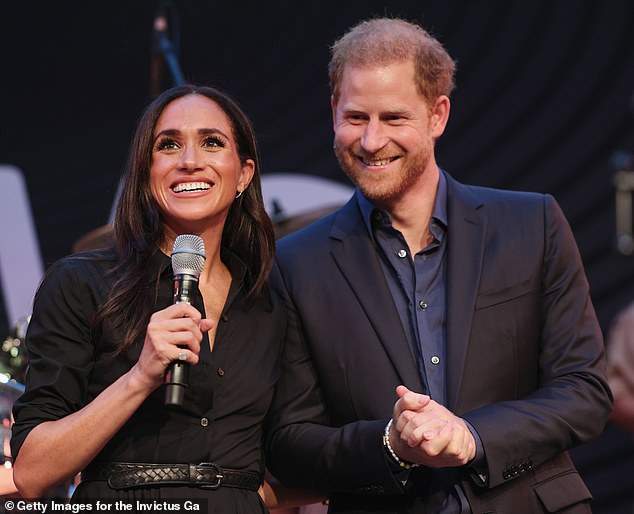 Meghan Markle was trying to show 'closeness' with Prince Harry (pictured together) and 'it was important to her that they appear side-by-side' at her first Invictus Games event this year, a body language expert has claimed