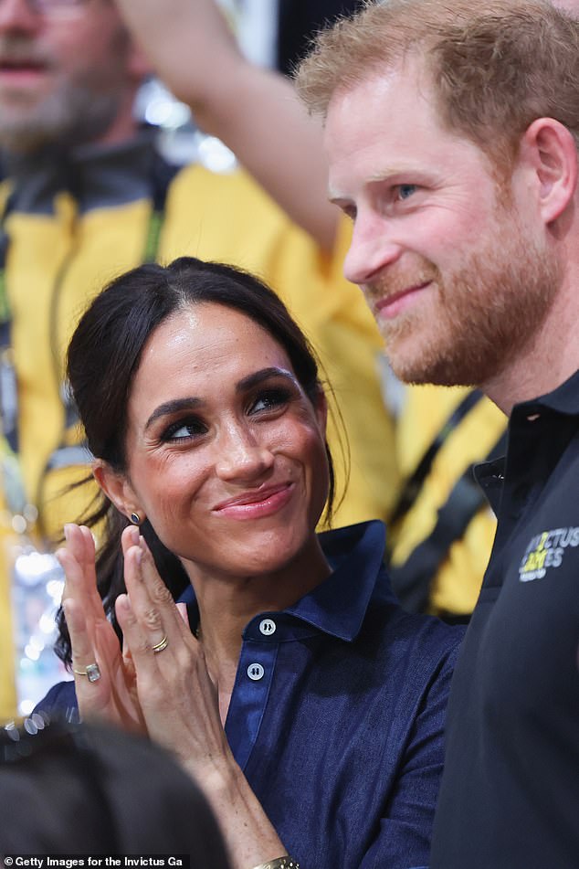 Meghan beams at Prince Harry during the medal ceremony for the victorious Poland team during the sitting volleyball final