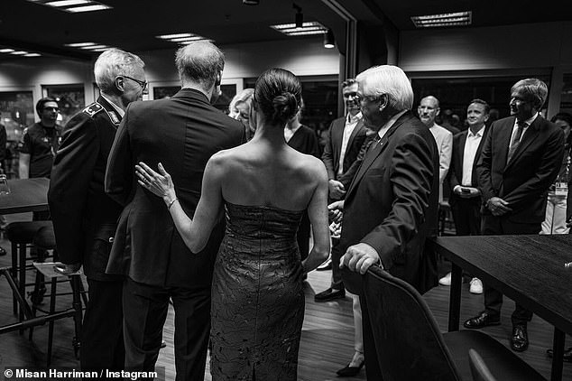 Another captured the mother-of-two, 42, affectionately placing her hand on the Duke's back as he chatted to guests, with the Duchess thought to be wearing her strapless £830 Cult Gaia dress