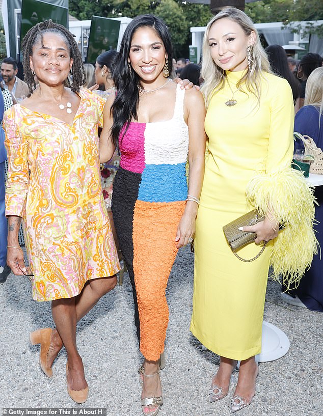 The grandmother of Prince Archie and Princess Lilibet (pictured left) accessorised with tan suede pumps and a gold necklace with white pendants