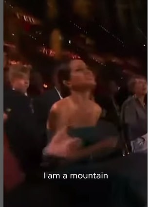 Meghan is seen singing