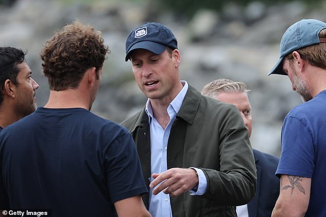 William donned a smart blue shirt and a khaki jacket as he joined the team before wading through the river