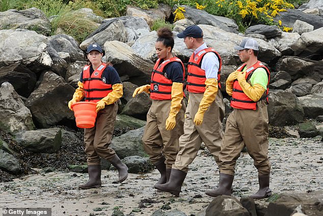 The Prince talks with members of the project as he walks along the New York foreshore