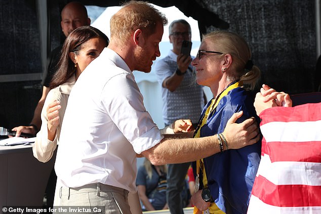 Yulia Paievska receives a medal at Invictus games from Prince Harry and Meghan