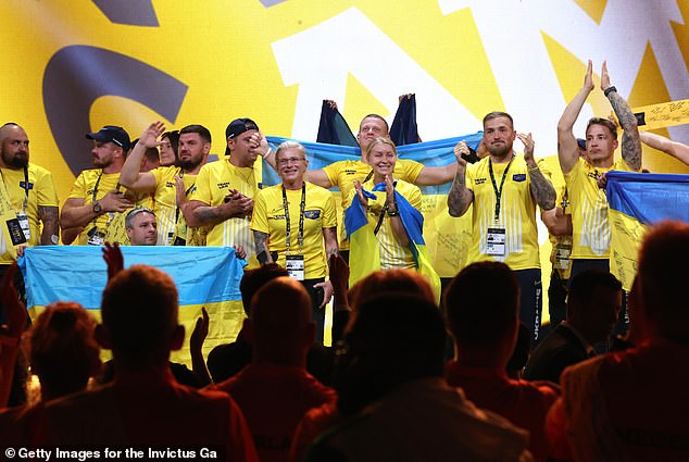 The Ukraine team entered the stage for the closing ceremony to a standing ovation, clutching Ukrainian flags and applauding