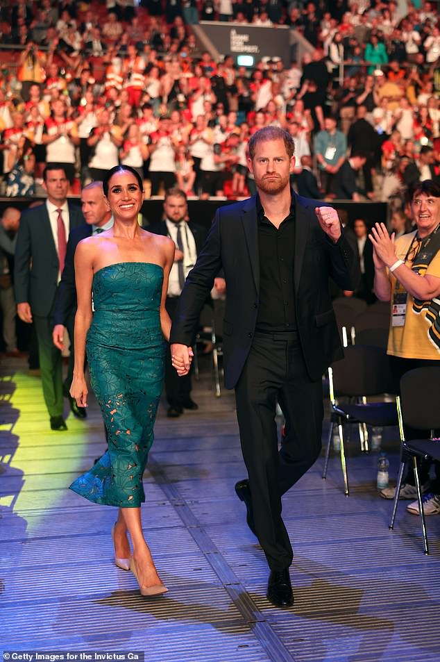 On cloud nine: Meghan beams and Harry pumps his fist as the Invictus Games draw to a close