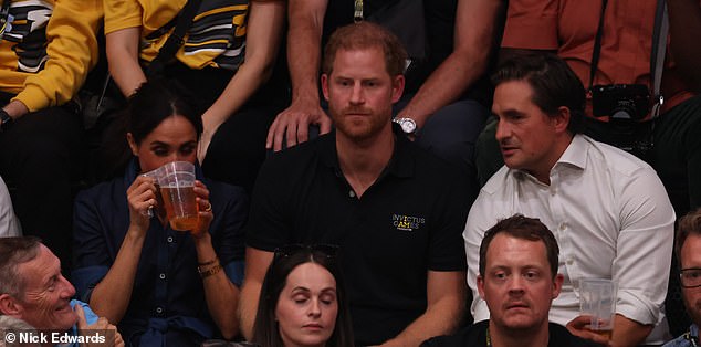 Meghan was spotted sipping a pint of beer which Harry had handed to her