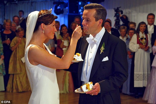 The author, whose last book Inferno was described as 'oozing with despair and sadness', also said he feared he would not be around to raise his three daughters. He is pictured at their wedding in historic Trondheim cathedral in May 2002