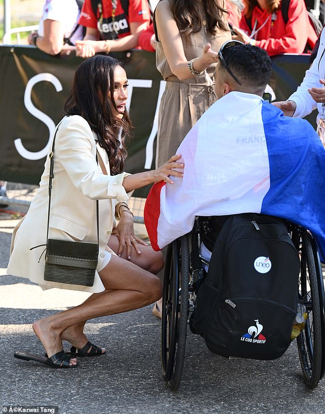 Meghan knelt to speak to a member of Team France