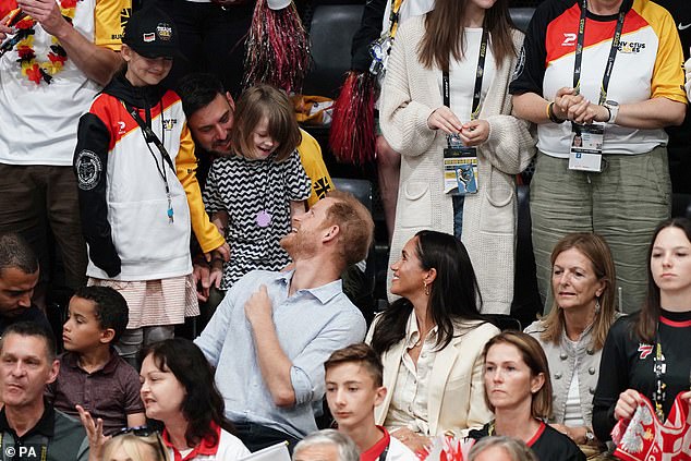 The Duke and Duchess of Sussex meet a little girl at the Merkur Spiel-Arena this morning