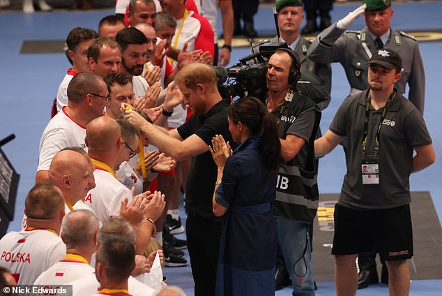 Meghan and Harry hand out gold medals to Poland following the game