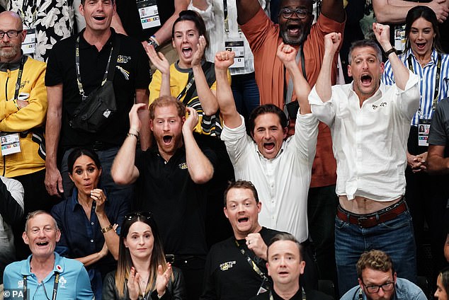 The lively crowd at the volleyball final jump out of their seats as point are scored