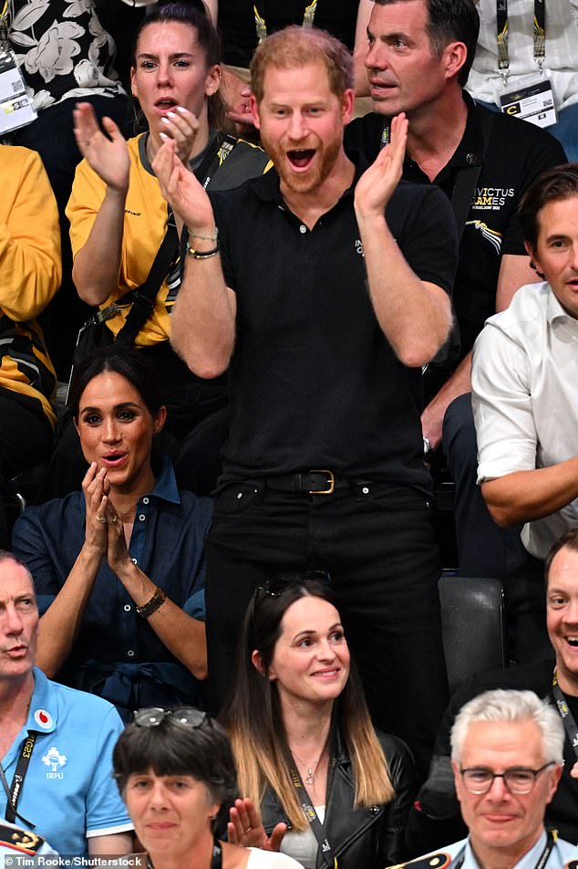 Harry is spotted jumping up to cheer during the final of the volleyball match in Dusseldorf