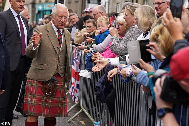 The band continued to  play as King Charles progressed down the street