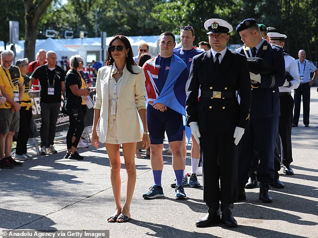 The mother-of-two sports a matching cream playsuit and blazer in the short video, which she pairs with flat black sandals