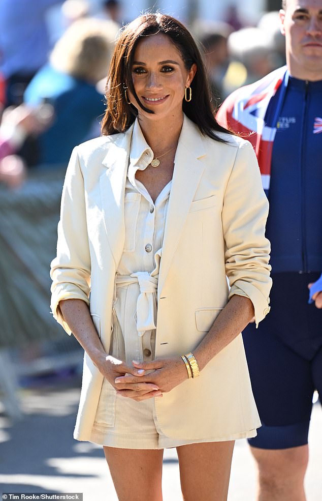 The Duchess of Sussex, 42, opted for a monochrome ensemble in the two tones of off-white when attending a seated volleyball match in Dusseldorf, Germany , with the Duke, who turns 39 today