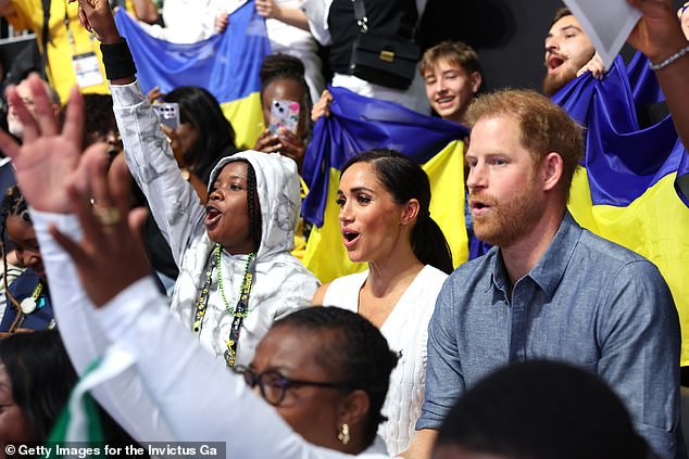 The animated couple were seen cheering on the teams as they stood with crowds watching the Ukraine vs Nigeria match