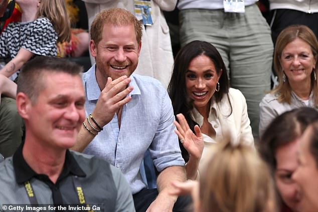 A young fan turned to offer a wave to Harry and Meghan, who are in Germany without their own two children, Archie, four, and Lilibet, two, who've stayed in California