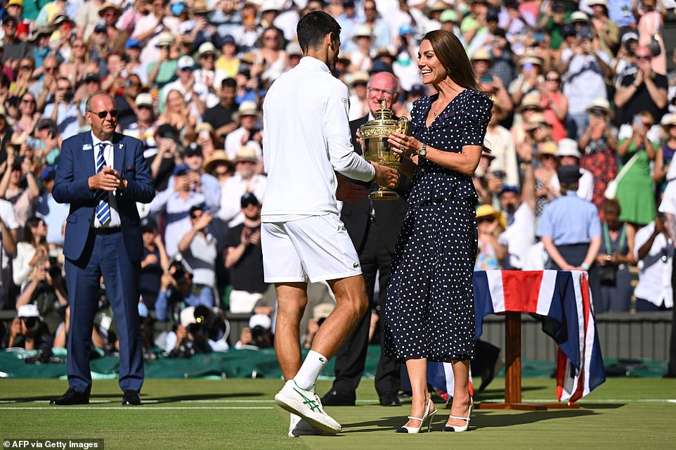 Back in 2016, when he was only four years old, doting mother Kate hinted that Prince George could be a future Wimbledon star when she revealed that he had a racket and was already playing tennis. She told Briton Greg Rusedski, who was in the men's invitational doubles, that George has already taken an interest in the game, despite being just two years old. Pictured: Kate awarding Pictured: Kate Middleton handing Novak Djokovic the winners trophy following the match.