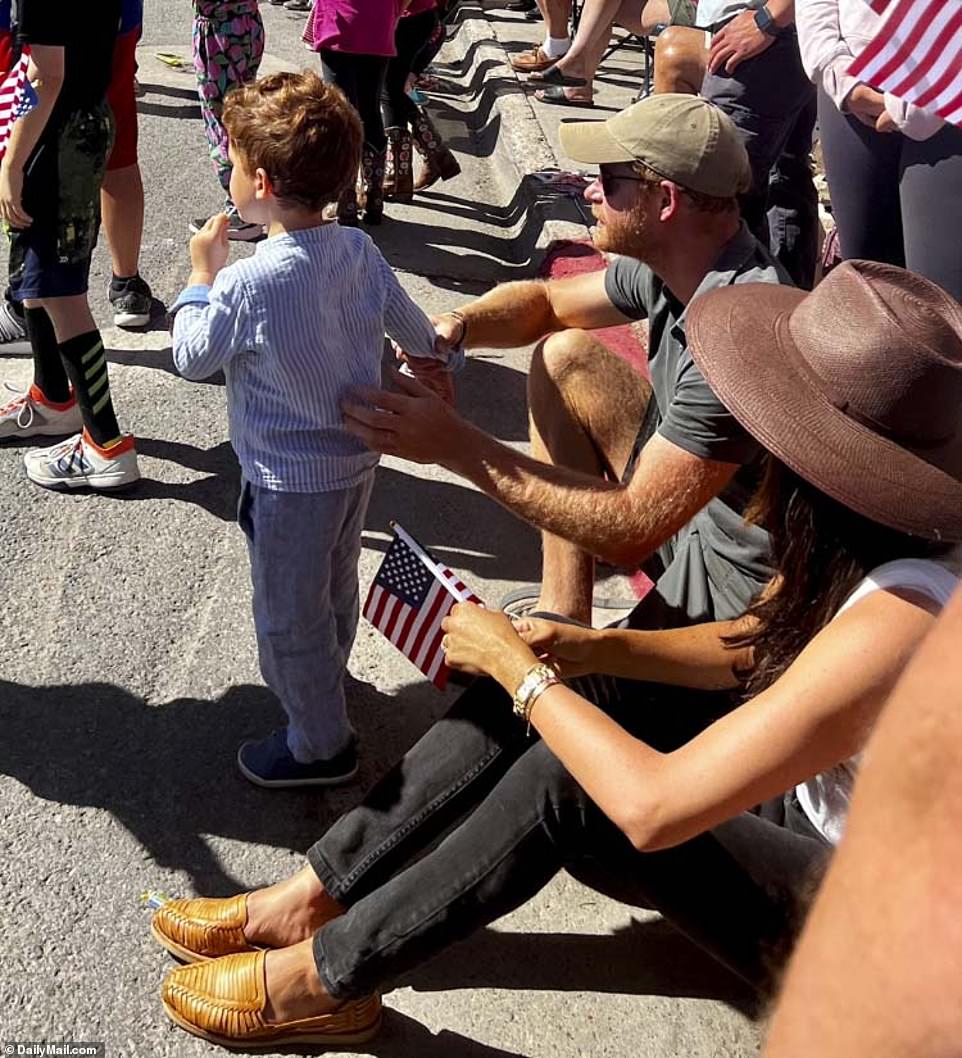 But onlookers say the cagey couple appeared to let their guard down in picturesque Jackson Hole, a trendy ski resort town where Kanye West, Sandra Bullock and Harrison Ford own pricey property. In fact the Sussexes made such a favorable impression that one parade-goer ¿ a fellow Brit - was overheard urging them to swap their ritzy Californian life for the Cowboy State, telling Harry: 'You'd fit right in here.'