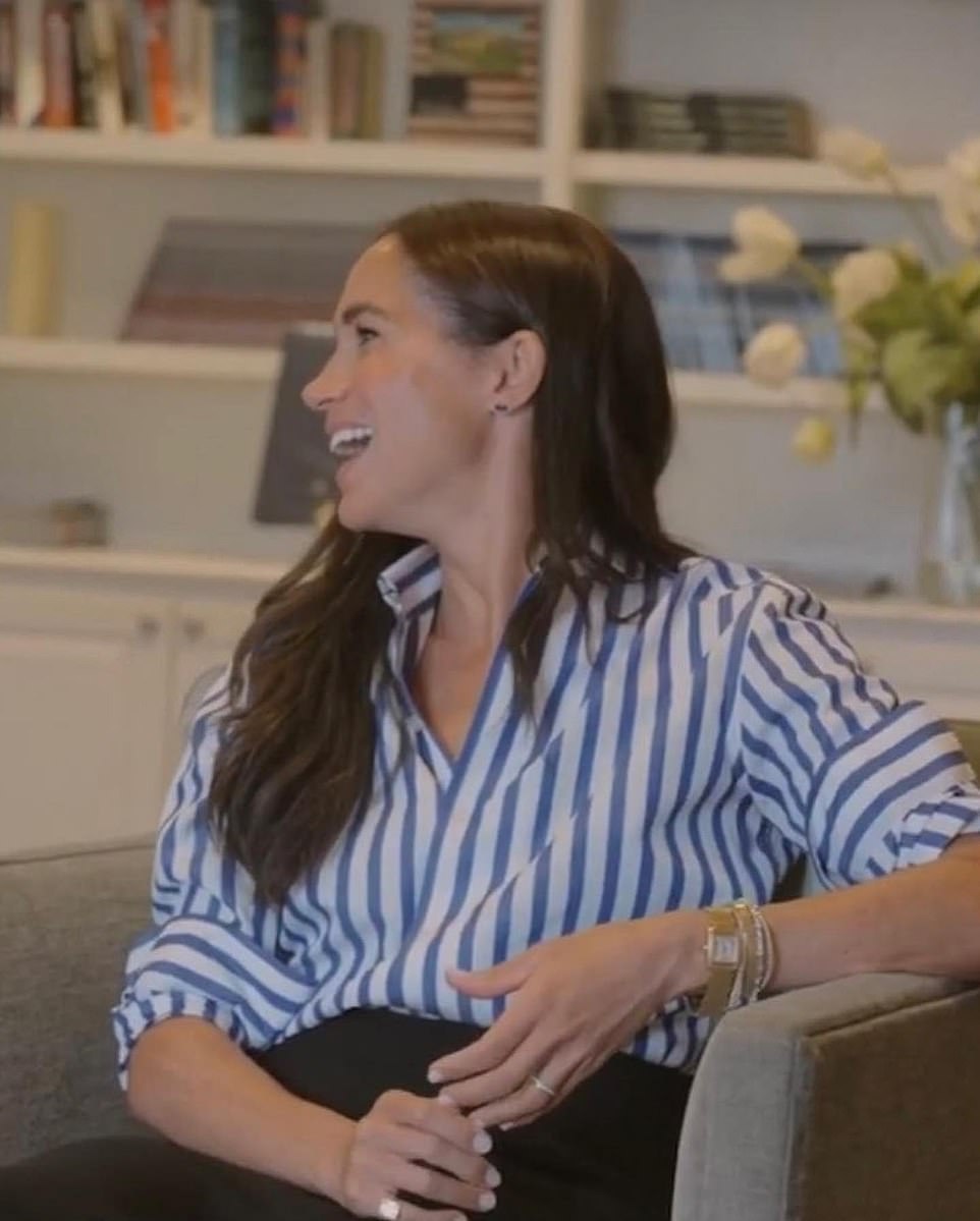 Meghan also made a subtle nod to Kate Middleton with her look, by wearing her Ralph Lauren Collection button down shirt in blue and white stripe that she first wore to Wimbledon Ladies final in 2019 alongside her sister-in-law. She paired it with her Lafayette 148 ¿Rafferty¿ midi skirt in black. The royal added Princess Diana's Cartier watch and her £50,000 Lorraine Schwartz pinky ring made with 'diamonds gifted from the Middle East' with various other bracelets.