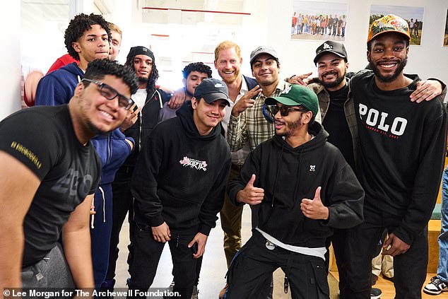 During the visit, the pair attended a 'mindful meditation session' during which Harry - seen posing with students - advised the group to keep track of one another's wellbeing