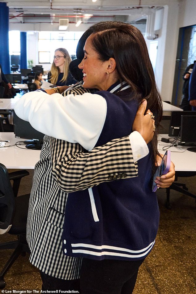 Images shared by Harry and Meghan's friend and go-to media member Omid Scobie show the duo posing alongside several students at the school. The Duchess is pictured sneaking in a hug