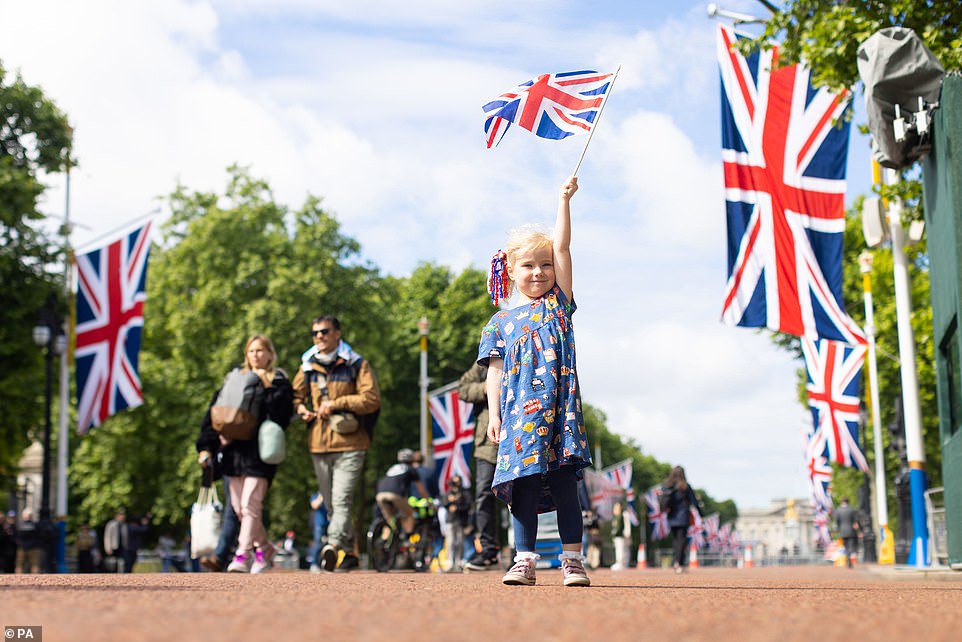 Drew, four, from Norwich, waves her Union flag on The Mall near Buckingham Palace, during a family day trip ahead of the Platinum Jubilee celebrations on Wednesday June 1, 2022