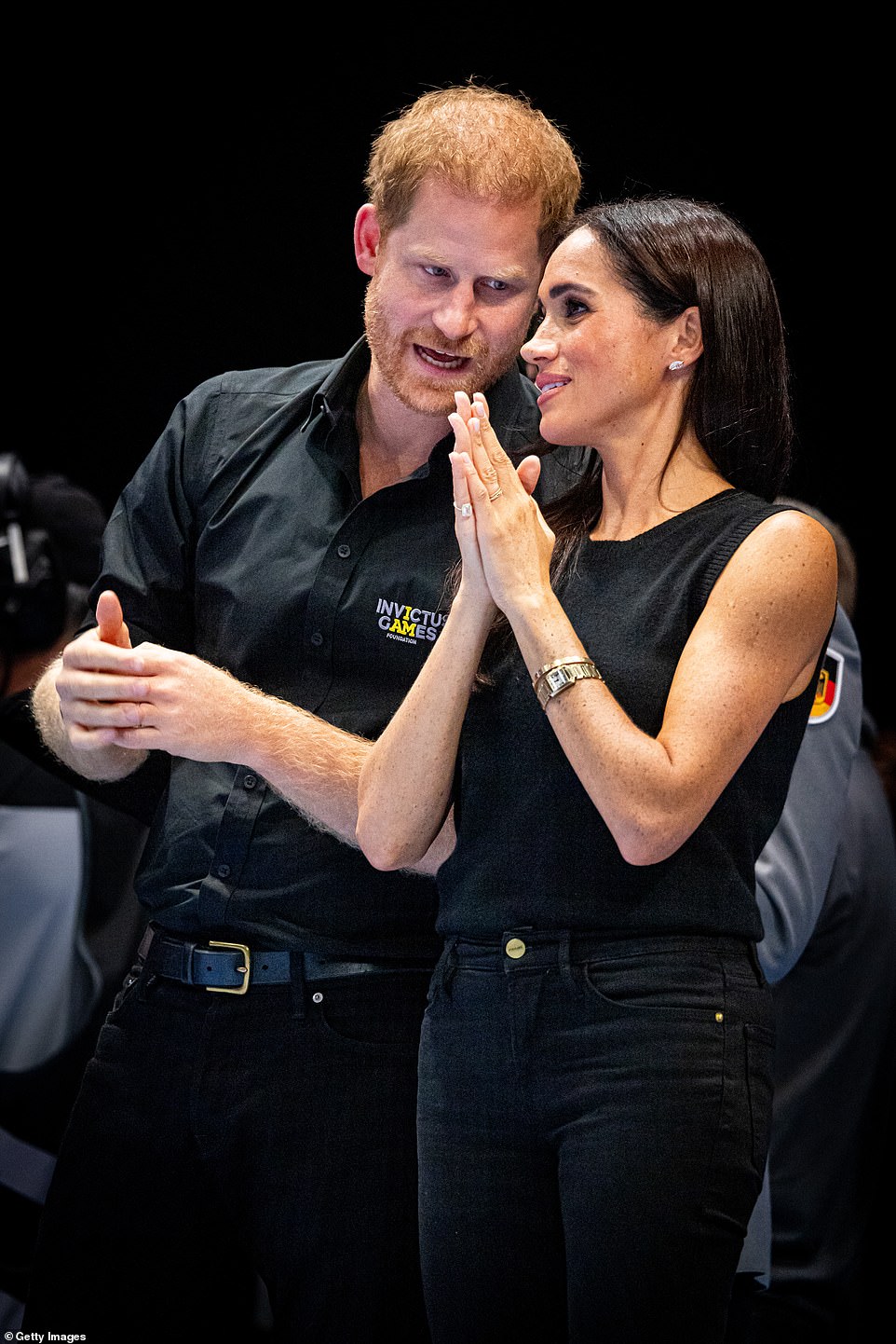 The Duchess of Sussex, 42, sported a monochrome brown outfit with high-end accessories, including £1200 silk trousers, £165 oversized Miu Miu sunglasses, and a £365 Dani Blouse. She paired the look with £590 Manolo Blahnik heels, Princess Diana's £17,800 Cartier watch, and a $2,800 1972 tennis pinky ring from Shiffon and Co, replacing her previous Lorraine Schwartz pinky ring. She completed her outfit with a £5,000 Cartier love bracelet while joining Prince Harry at the Invictus Games.