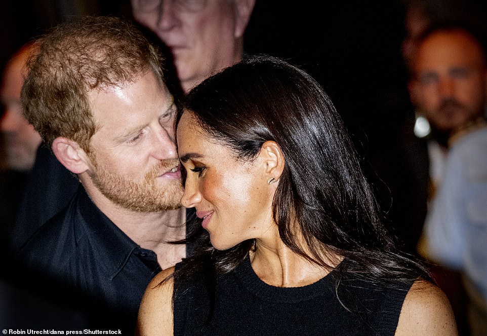 During the Swimming Finals at the Invictus Games, Meghan Markle wore £620 cream Hermès Get sneakers, along with £2,000 Luna Skye earrings featuring baguette diamonds and leaf-shaped design.