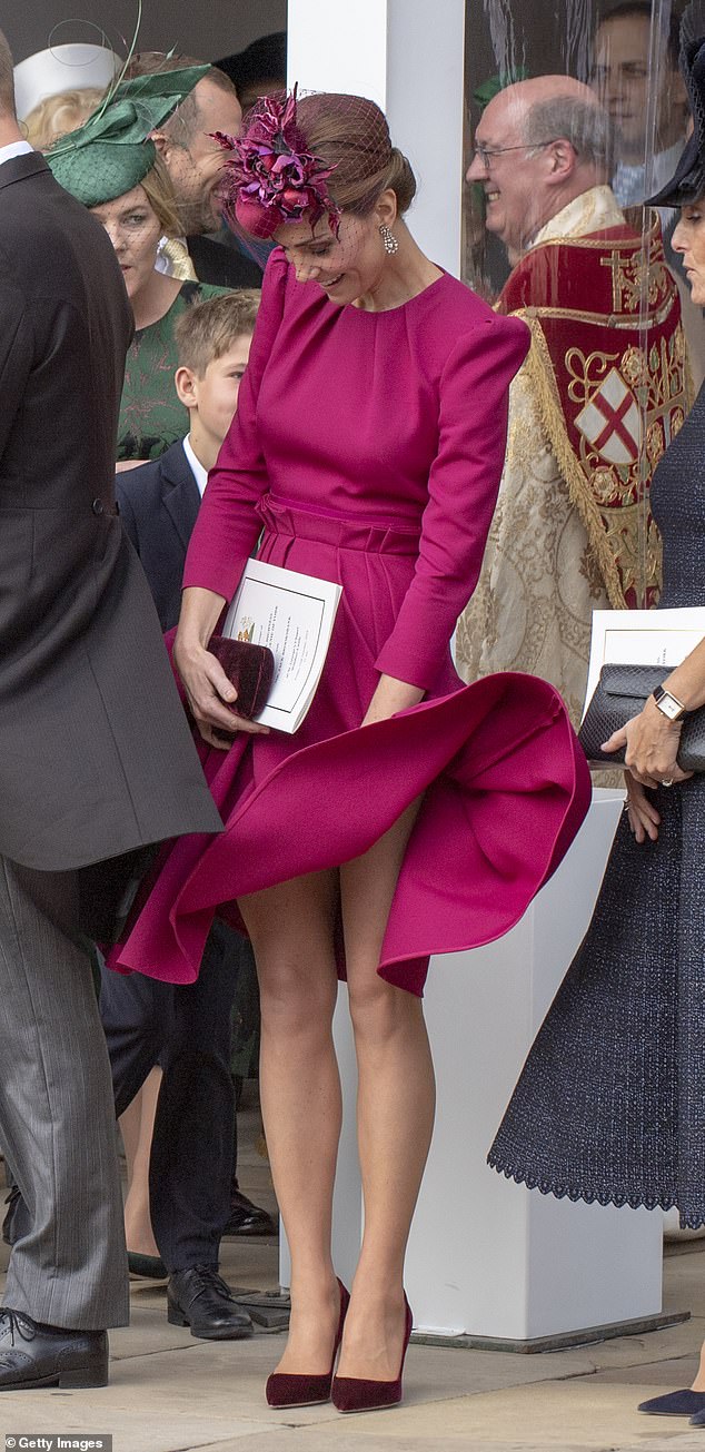 Kate, the Princess of Wales wards off a gust of October wind before the ceremony